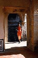 Therese is splashed with some late afternoon sun as she walks through the interior of the Convento Christo